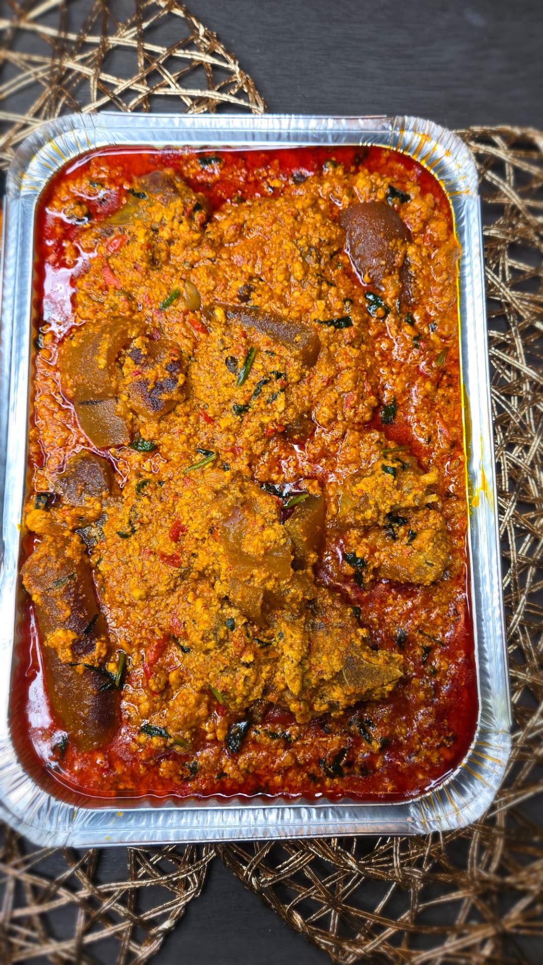 Bowl of Nigerian egusi soup with assorted meat
