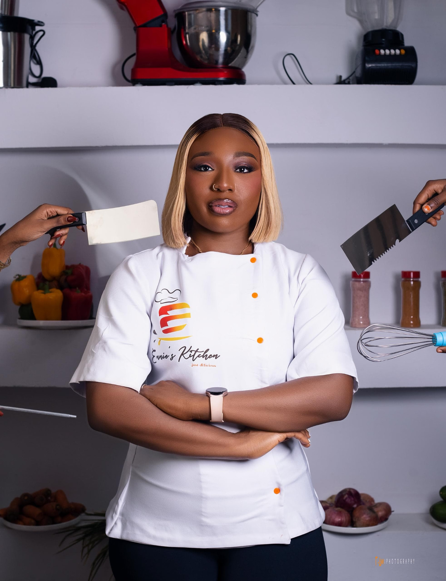 Ennie, founder and chef of Ennieskitchen, wearing chef whites.